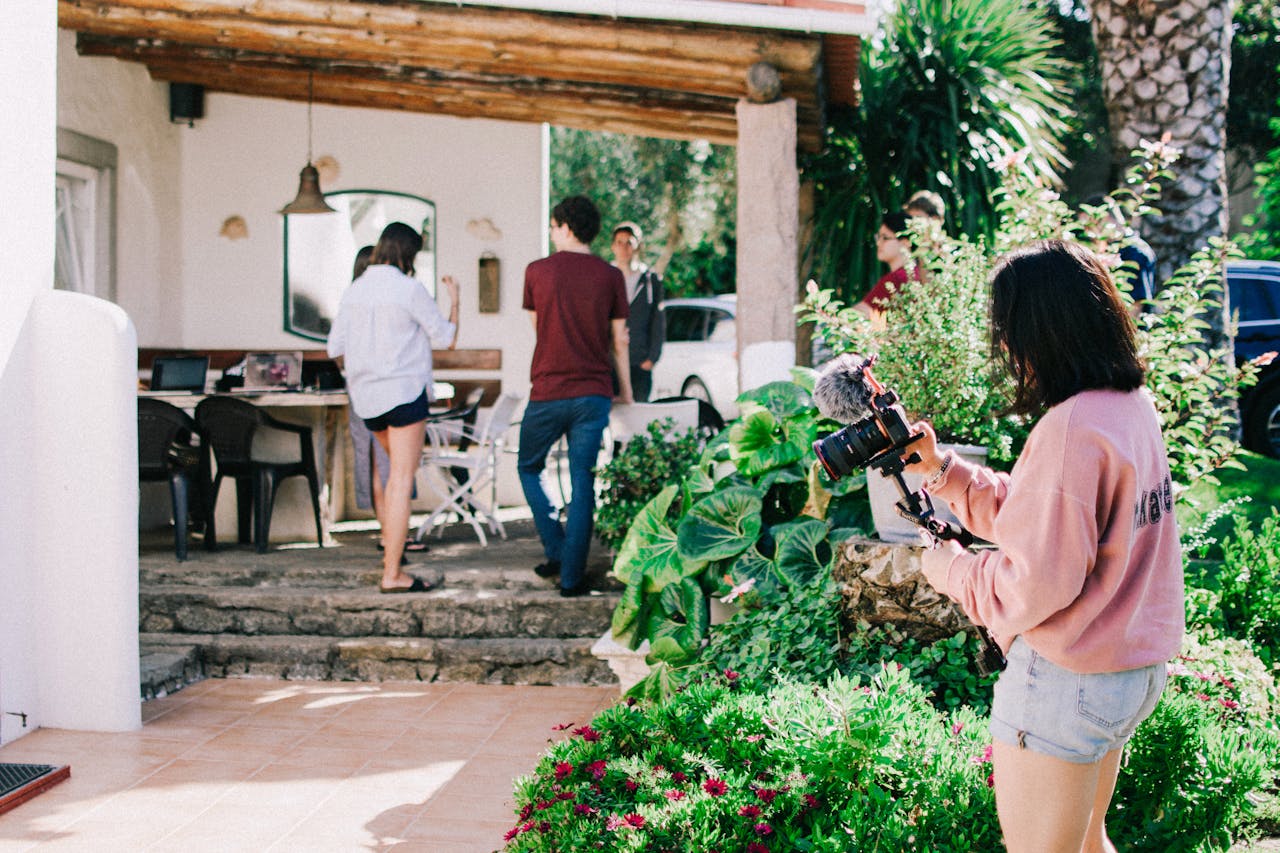person-with-camera-in-front-of-house person-with-camera-in-front-of-house