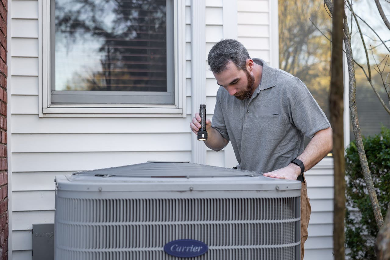 person-checks-HVAC-system person-checks-HVAC-system
