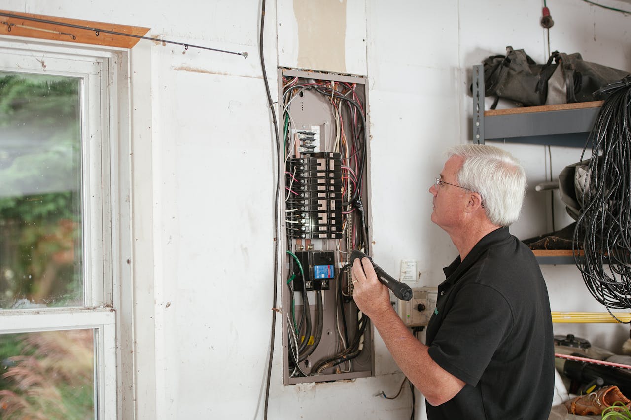 person-checks-breaker-box person-checks-breaker-box