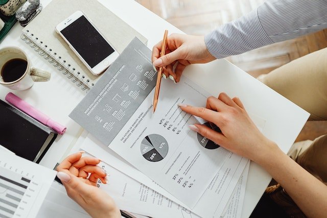 a-person-reading-data-documents-at-a-desk a-person-reading-data-documents-at-a-desk